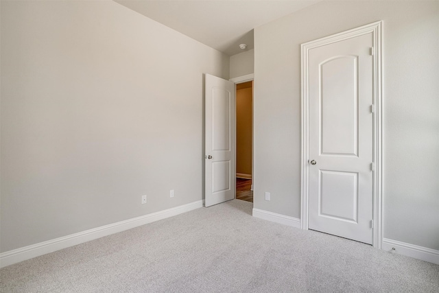 unfurnished bedroom with light colored carpet