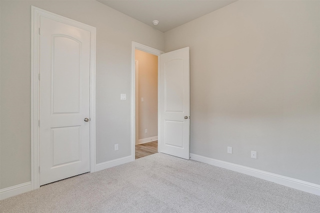 unfurnished bedroom featuring light carpet