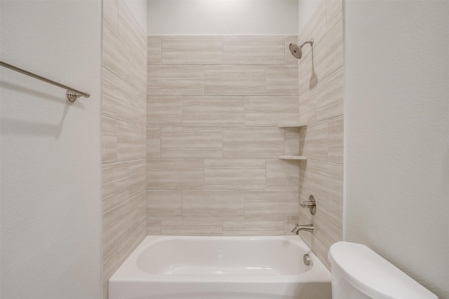 bathroom with toilet and tiled shower / bath combo