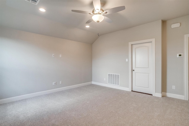 carpeted spare room with vaulted ceiling and ceiling fan