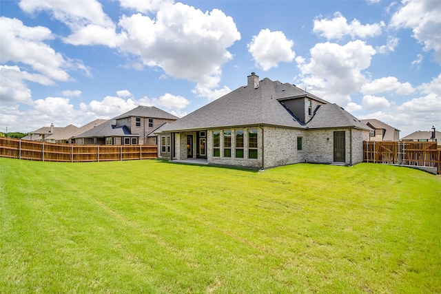 5621 Rutherford Dr, Midlothian, TX 76065 - rear view of property with a lawn, a fenced backyard, and brick siding