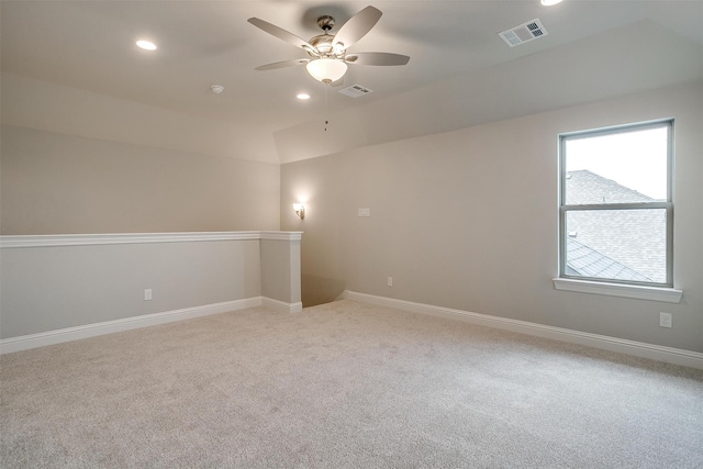 carpeted spare room with lofted ceiling and ceiling fan