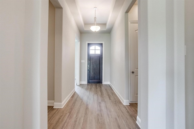 5621 Rutherford Dr, Midlothian, TX 76065 - doorway to outside featuring baseboards, light wood-style flooring, and a tray ceiling