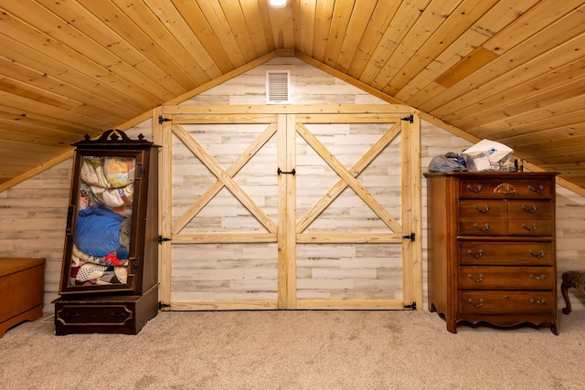 interior space featuring wood walls, wood ceiling, vaulted ceiling, and carpet flooring