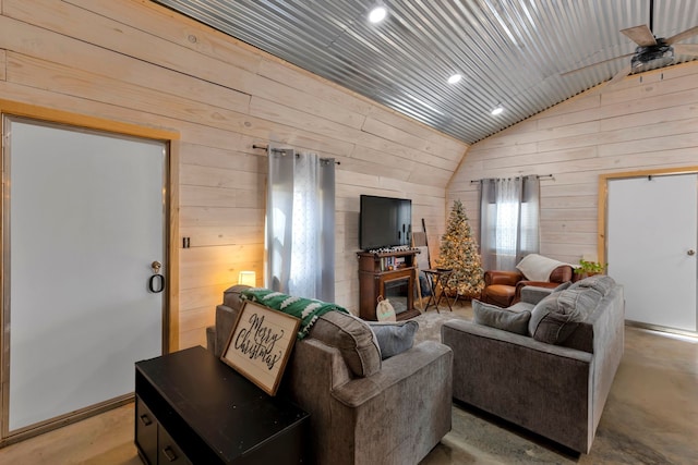 living room featuring wooden walls, ceiling fan, vaulted ceiling, and wood ceiling