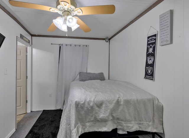 bedroom featuring ceiling fan, ornamental molding, and carpet