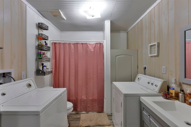 laundry area with washing machine and clothes dryer and sink