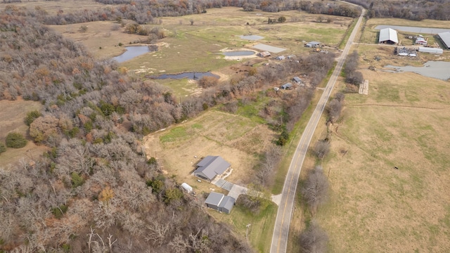 birds eye view of property featuring a water view and a rural view