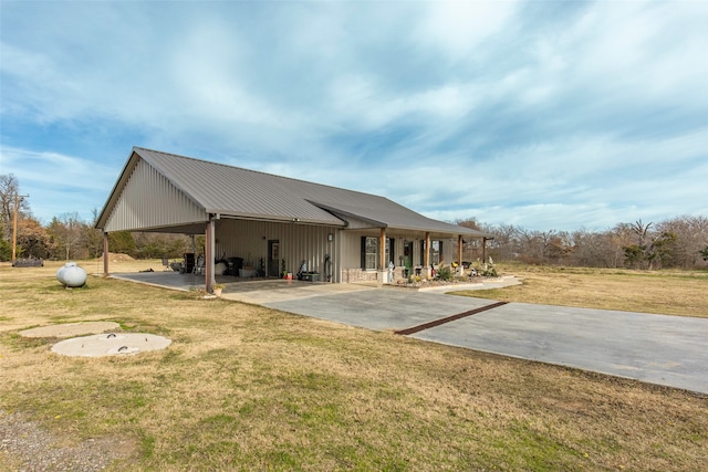 back of property with a yard and a patio