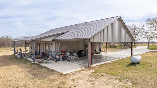 view of community featuring a lawn and a patio area