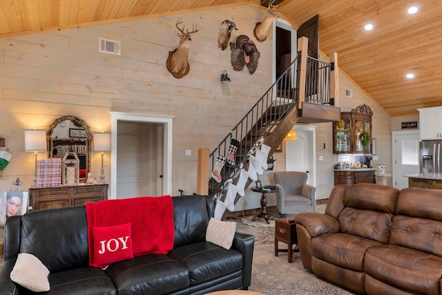 carpeted living room with high vaulted ceiling and wooden ceiling