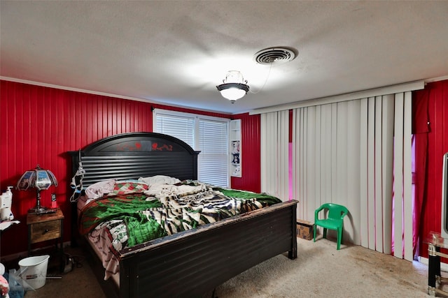 carpeted bedroom featuring visible vents