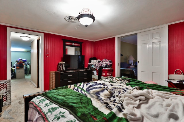 bedroom with ensuite bathroom and carpet flooring