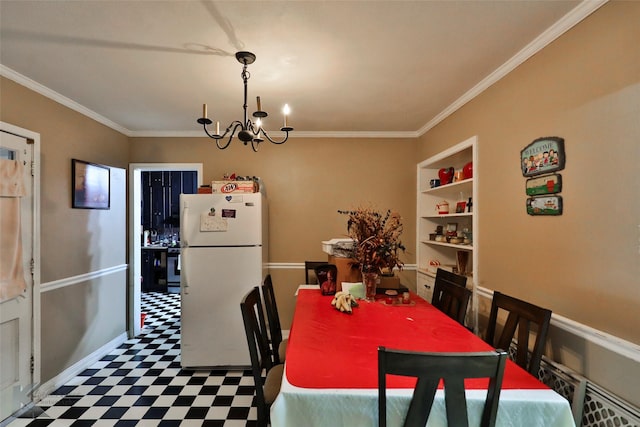 dining room with built in shelves, crown molding, a chandelier, and tile patterned floors