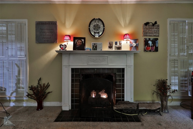 interior details with carpet flooring and a tile fireplace