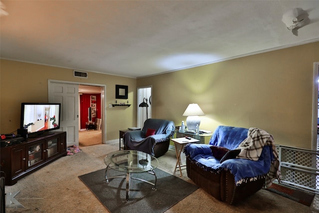 carpeted living room with ornamental molding