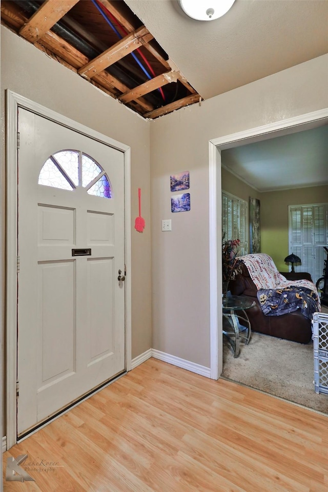 entrance foyer featuring baseboards and light wood-type flooring
