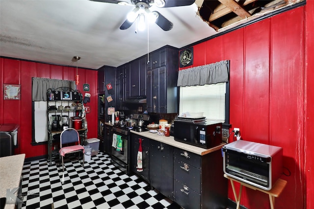 kitchen featuring ceiling fan, tile patterned flooring, and electric range