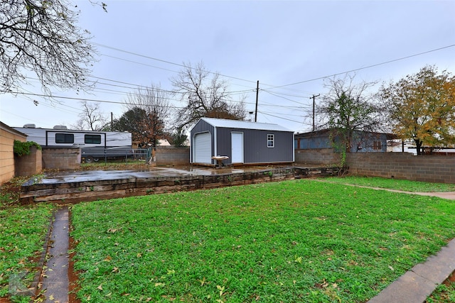 view of yard featuring fence and an outbuilding