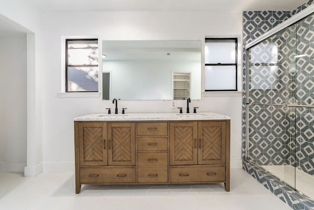 bathroom featuring tile patterned flooring, vanity, and a shower with shower door