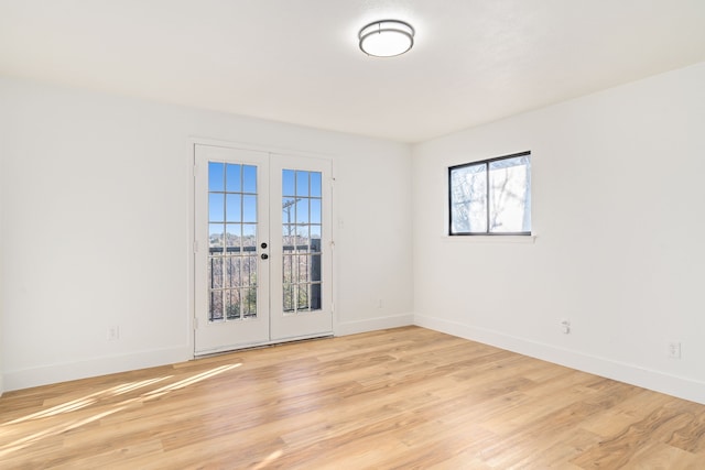 spare room with light wood-type flooring and french doors