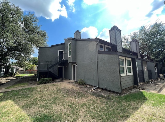 back of property featuring a yard