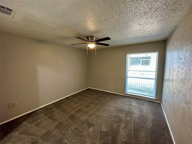 carpeted spare room featuring ceiling fan and a textured ceiling