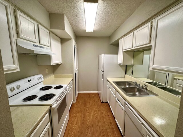 kitchen featuring sink, light hardwood / wood-style floors, a textured ceiling, white appliances, and white cabinets