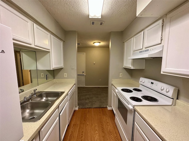 kitchen with white cabinetry, sink, hardwood / wood-style flooring, and white electric range