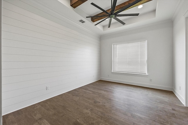 empty room featuring beam ceiling, wood-type flooring, a raised ceiling, and ceiling fan