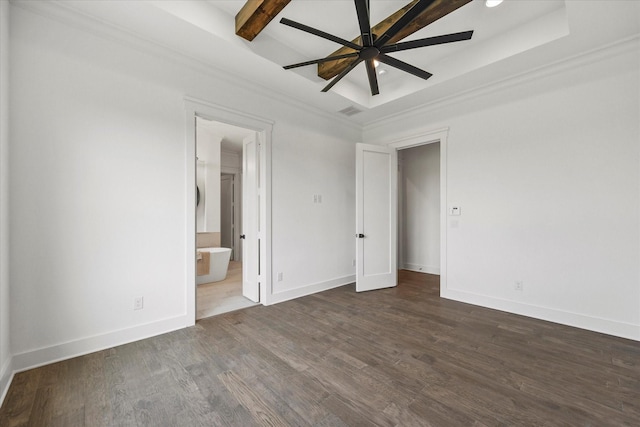 unfurnished bedroom featuring dark hardwood / wood-style floors, beam ceiling, ceiling fan, a tray ceiling, and ensuite bath