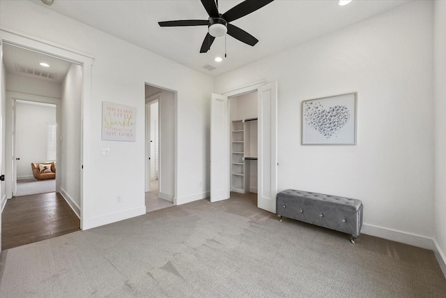 unfurnished bedroom with carpet floors, ceiling fan, and a closet