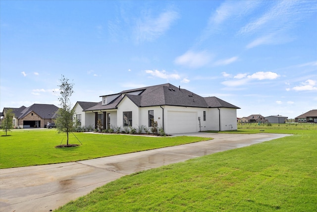 view of front of home featuring a front lawn and a garage