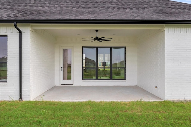 property entrance featuring a yard, a patio area, and ceiling fan