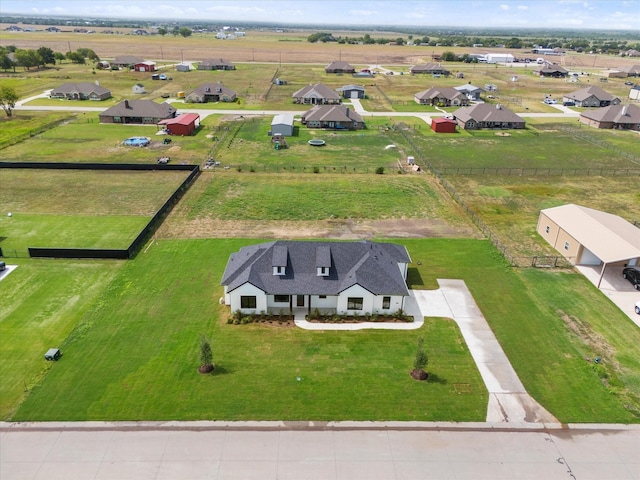 birds eye view of property with a rural view