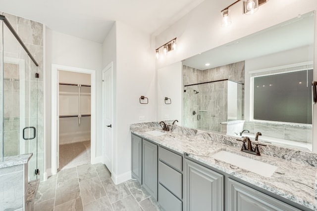 bathroom with an enclosed shower, tile floors, and double sink vanity