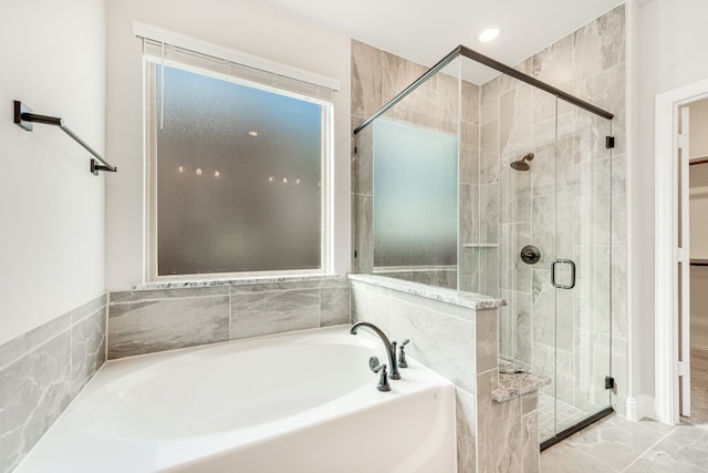 bathroom with independent shower and bath and tile flooring