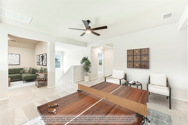 carpeted living room featuring ceiling fan