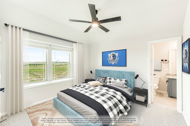 bedroom featuring light tile floors, connected bathroom, and ceiling fan