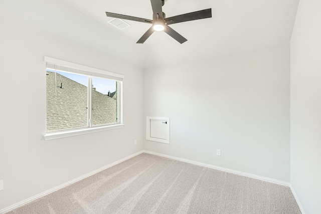 carpeted spare room featuring ceiling fan