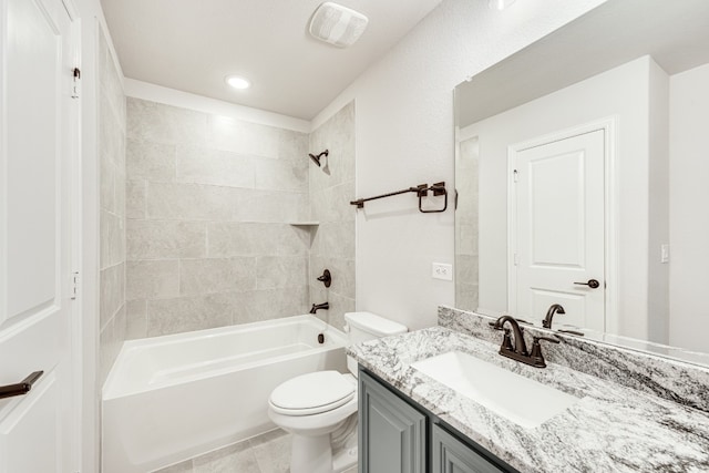 full bathroom with toilet, tile floors, tiled shower / bath combo, and vanity