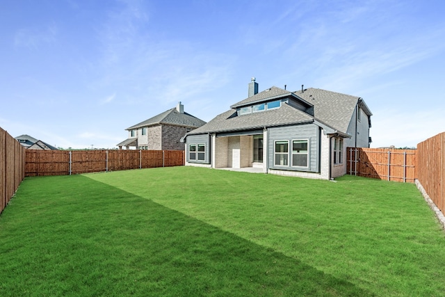 rear view of property with a lawn and a patio