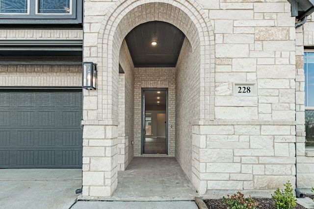 view of exterior entry featuring a garage