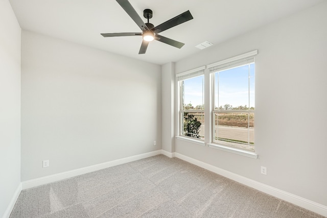 empty room featuring light colored carpet and ceiling fan