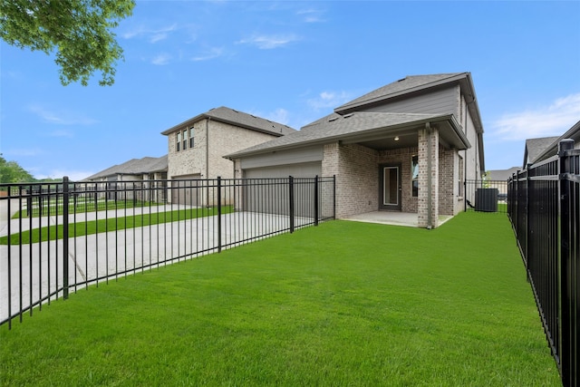 exterior space with a patio, a yard, and central AC