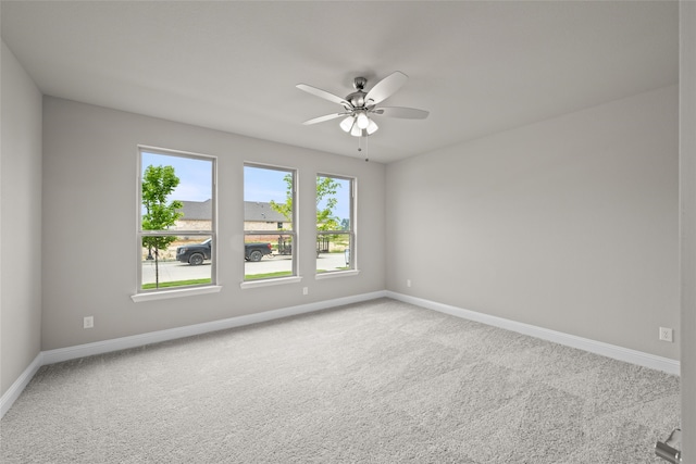 spare room featuring carpet and ceiling fan