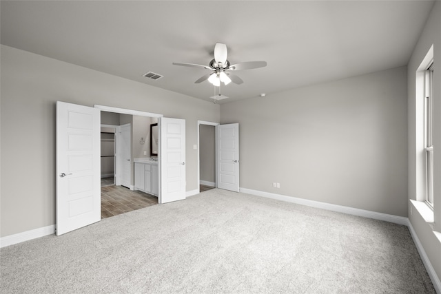 unfurnished bedroom with a closet, ceiling fan, and dark carpet