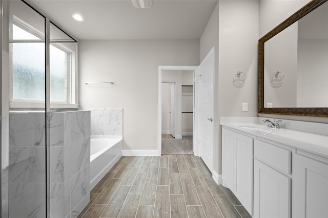 bathroom featuring a tub and oversized vanity