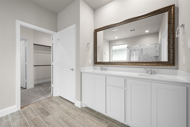 bathroom featuring walk in shower and double vanity