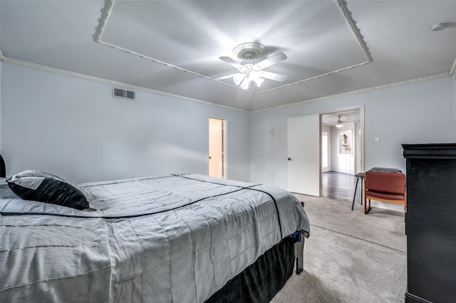 carpeted bedroom featuring crown molding and ceiling fan